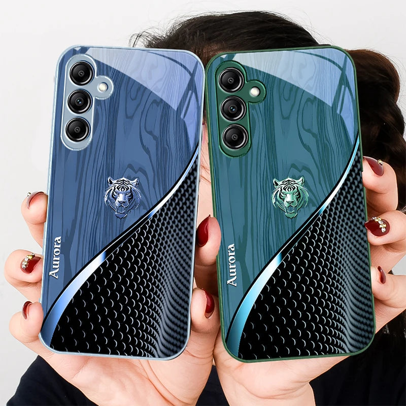 Clear glass phone case featuring a gold tiger design, designed to protect and stylishly showcase a smartphone.