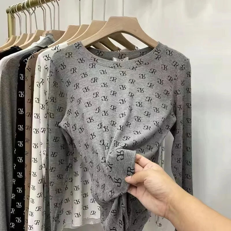Long-sleeve printed women's T-shirt by Corporación Turística, featuring a stylish design and comfortable fabric.