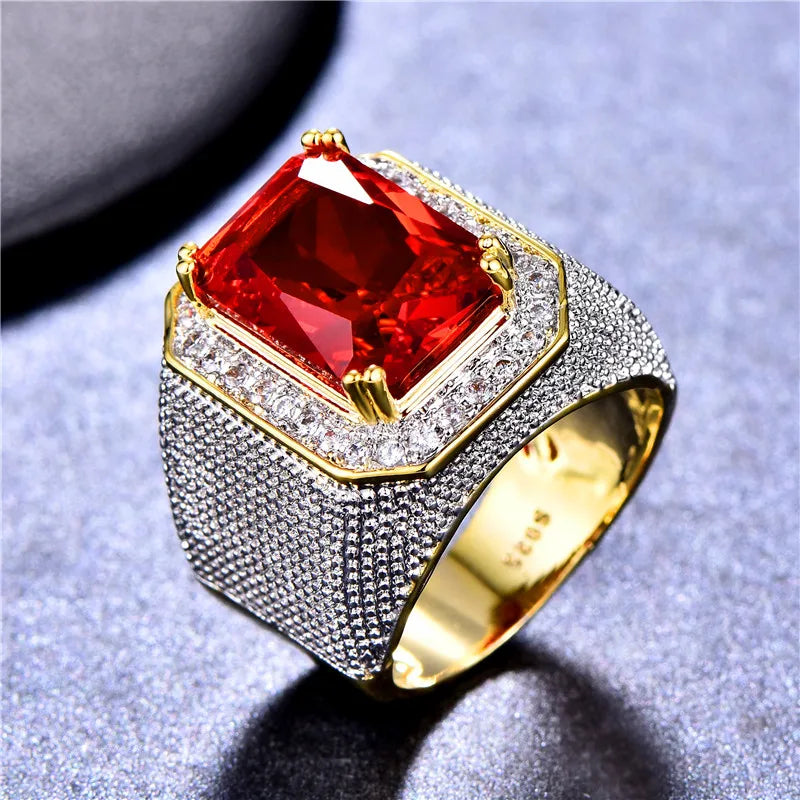 Large red cubic zirconia ring with a bold design, featuring a prominent gemstone setting, by Corporación Turística.