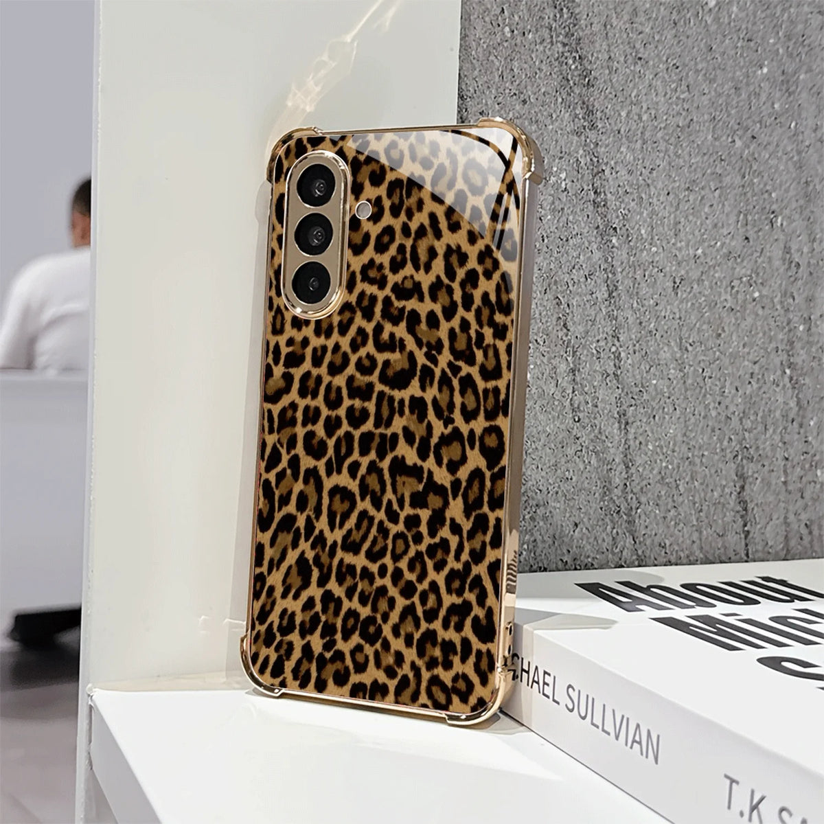 Gold-plated glass phone case from Corporación Turística, featuring a sleek, reflective surface and stylish design.