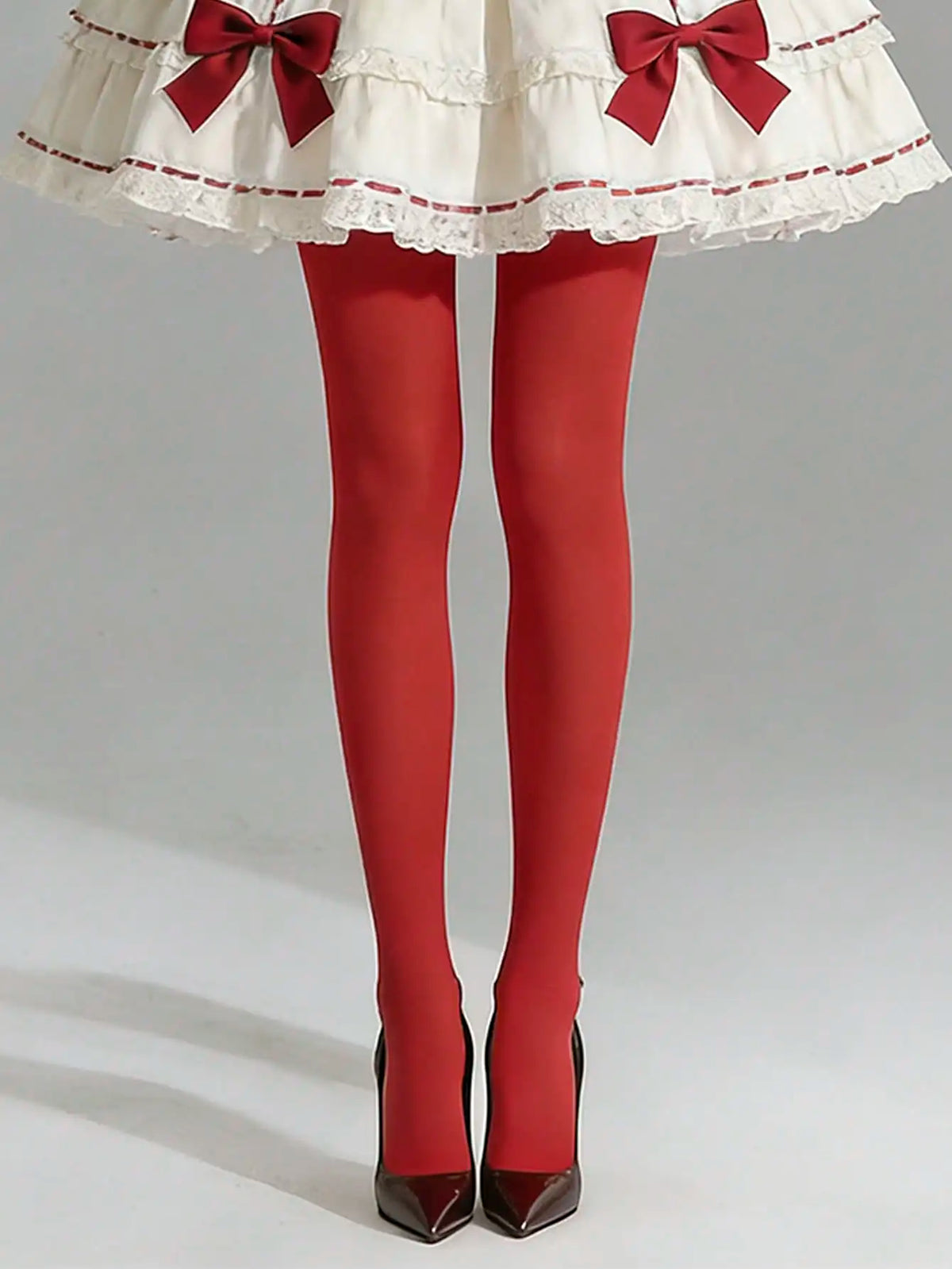 Pair of opaque red nylon pantyhose from Corporación Turística, showcasing smooth, ultra-elastic fabric and a comfortable fit.