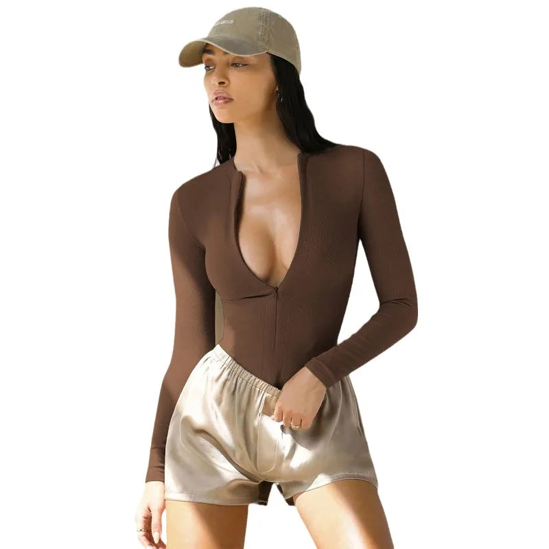 Long-sleeve cream ribbed jumpsuit for women by Corporación Turística, featuring a fitted design and stylish fabric details.