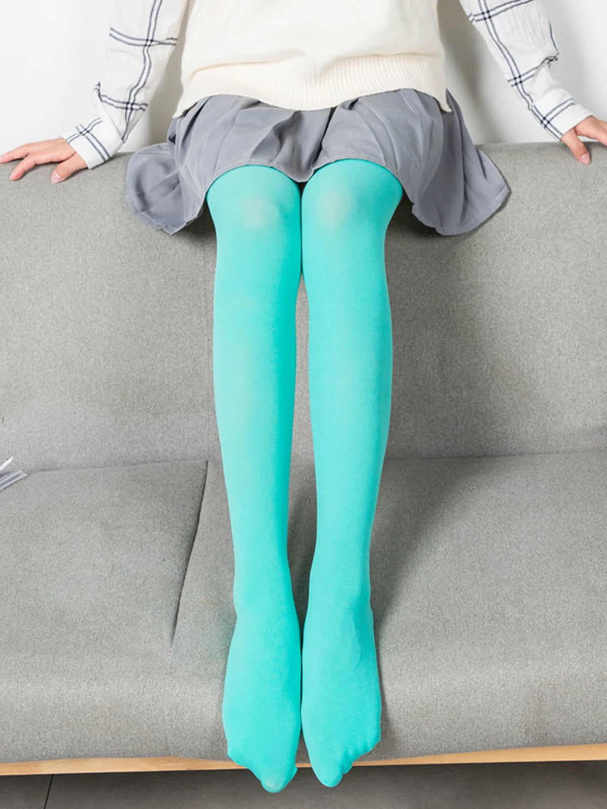 High elasticity women's tights in pastel colors, 80D, by Corporación Turística, shown in a close-up image highlighting fabric texture.
