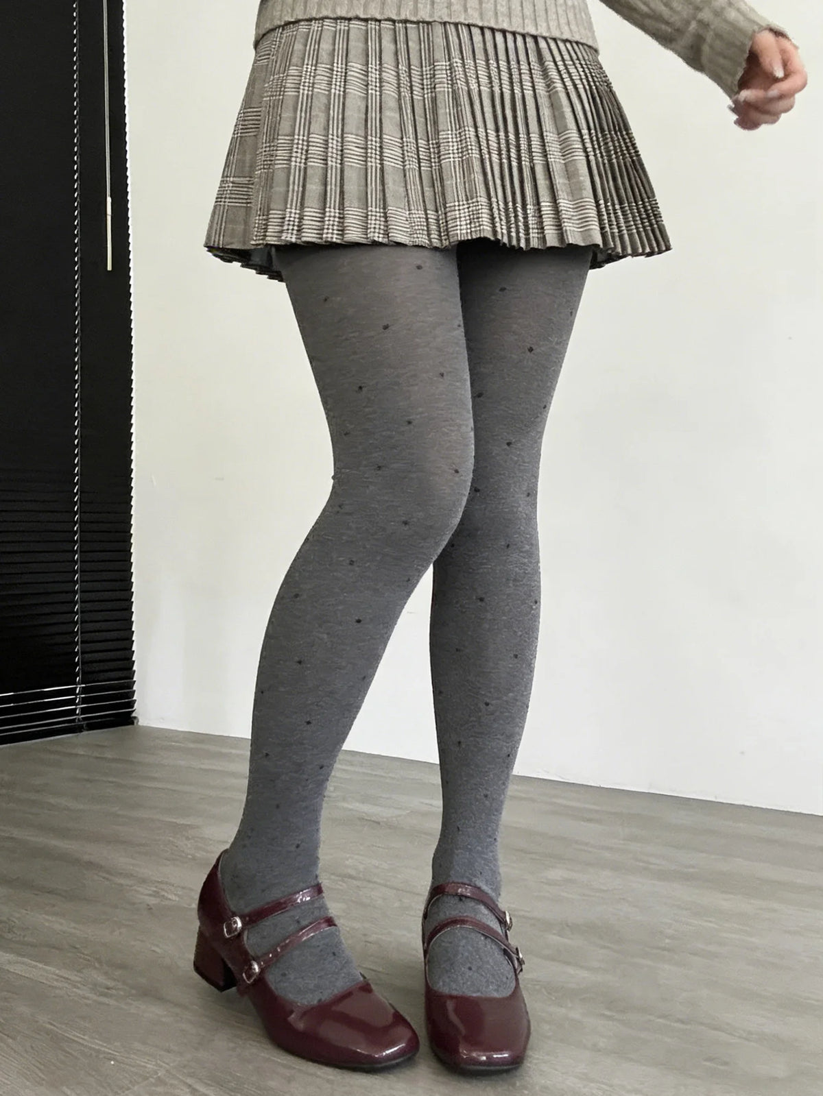 Gray vintage knit tights with small polka dot pattern from Corporación Turística, showcasing the textured fabric and classic design.