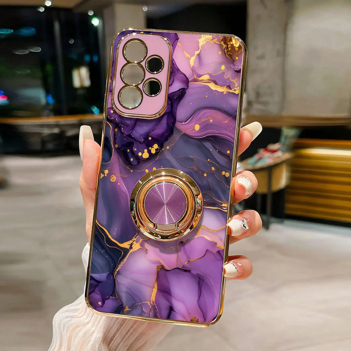 Phone case with ring stand featuring a marble pattern, designed for secure grip and style by Corporación Turística.