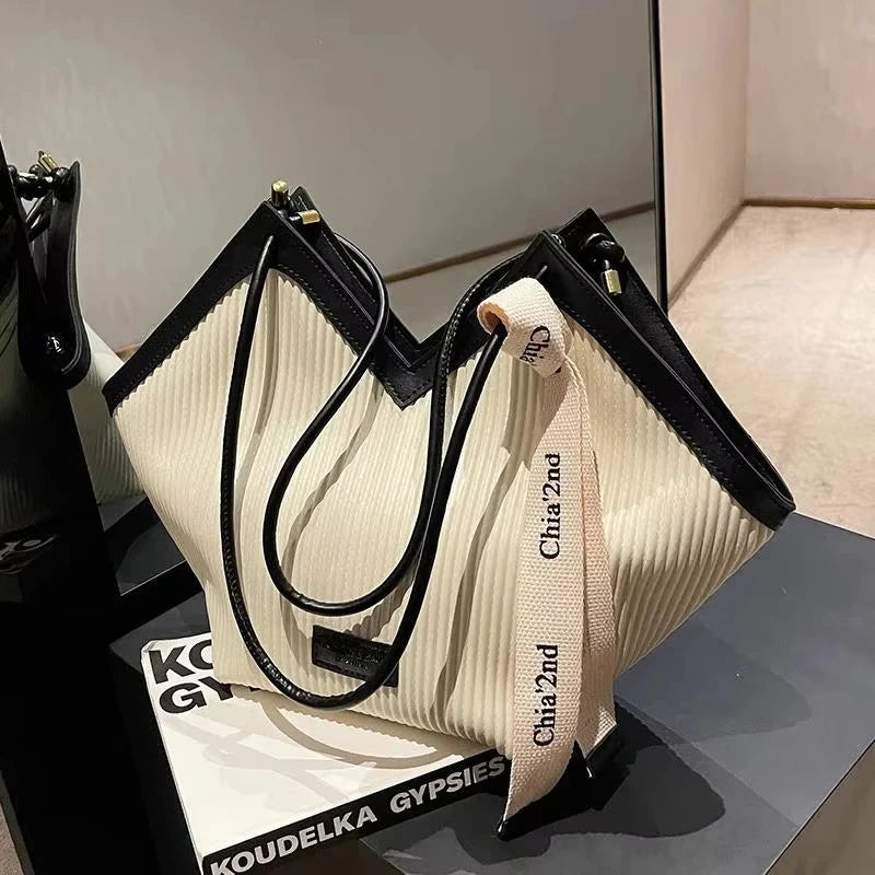 Large Korean-style women's tote bag made of canvas with sturdy straps and spacious interior, perfect for daily use.
