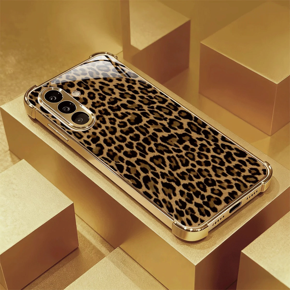 Gold-plated glass phone case with decorative design, designed for a smartphone, showcasing a luxurious and elegant protective cover.