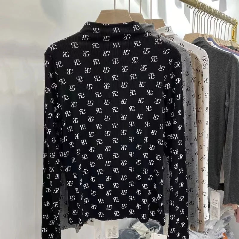 Long-sleeve printed women's T-shirt by Corporación Turística, soft fabric, casual style, shown in a close-up image.