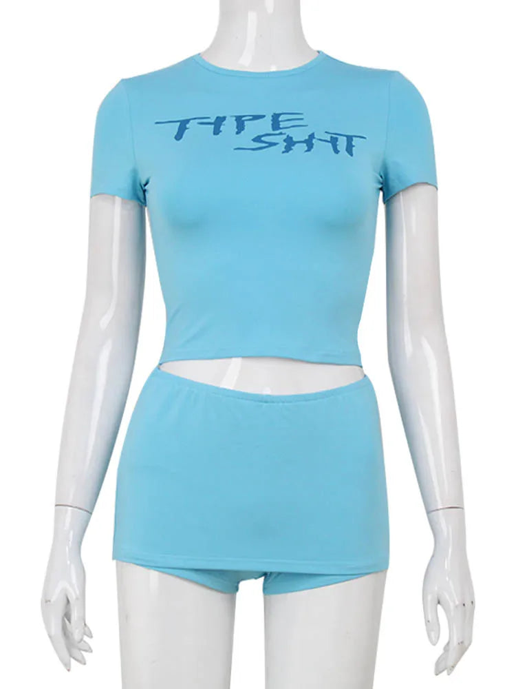 Two-piece crop top set with letter print from Corporación Turística, featuring colorful printed fabric and stylish design.