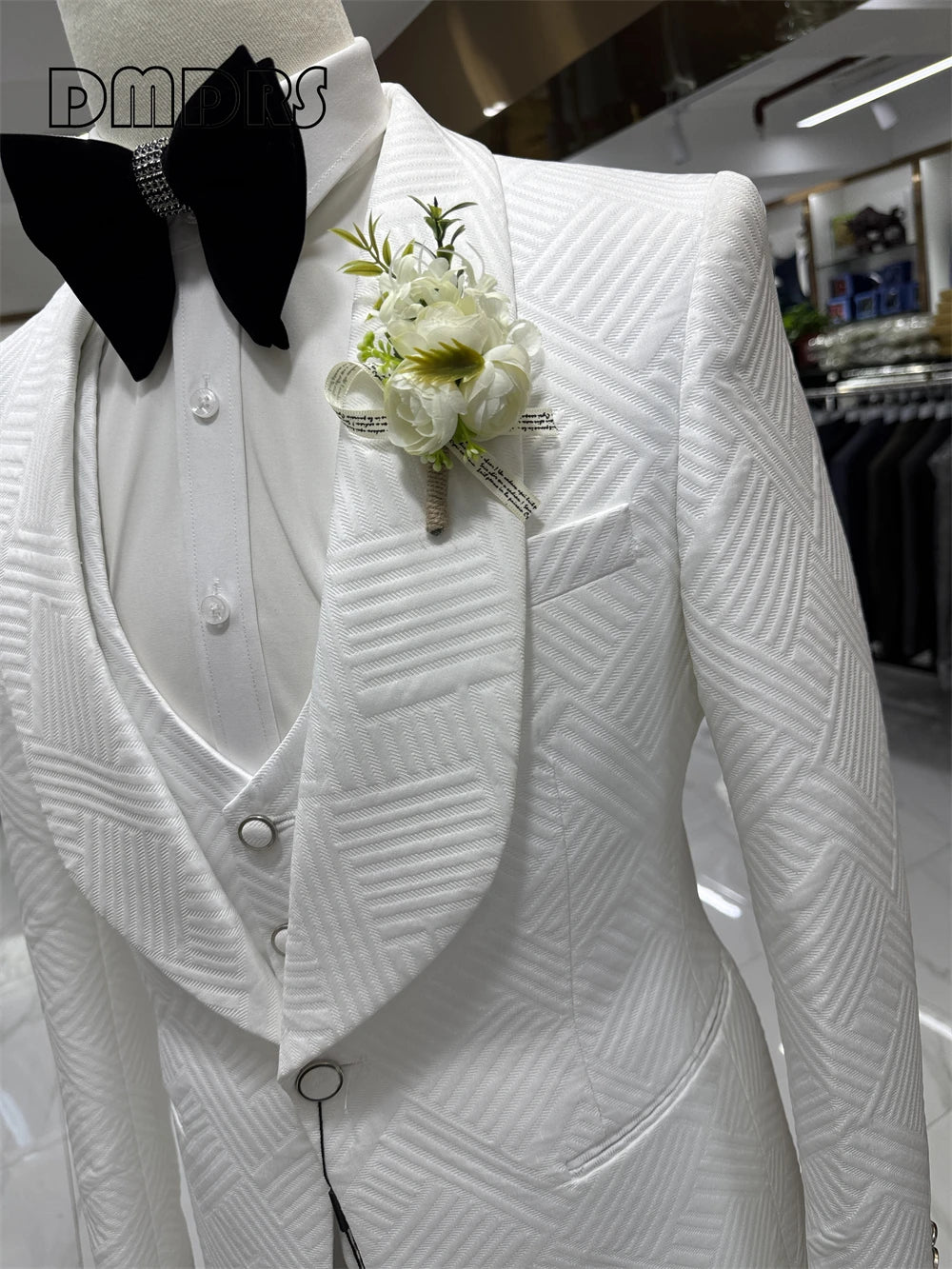 Elegant groom wedding suit from Corporación Turística, high-quality fabric, tailored fit, shown on a mannequin.