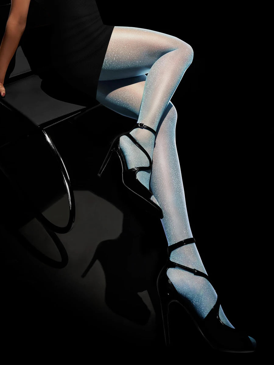 Pair of shiny transparent nude sexy Kave tights by Corporación Turística, showcasing their smooth, glossy finish and fit.