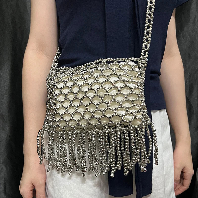 Handmade woven bag with bead details and tassels by Corporación Turística, featuring colorful textile craftsmanship.