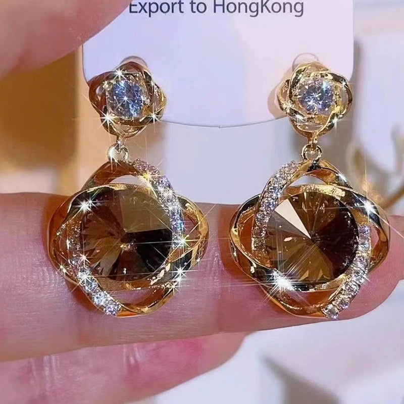 Pendientes con colgante de cristal redondo envuelto de di...