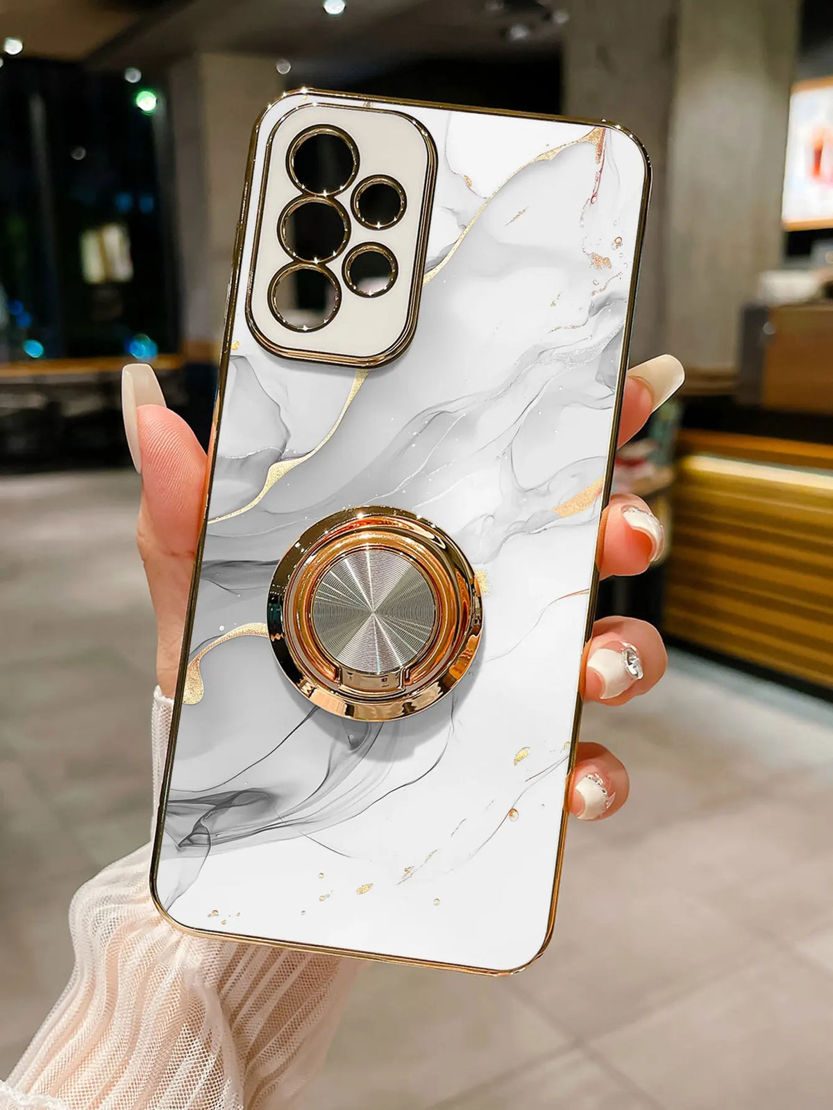 Phone case with ring stand featuring a marble pattern, designed by Corporación Turística, showing the stylish protective cover with ring holder.