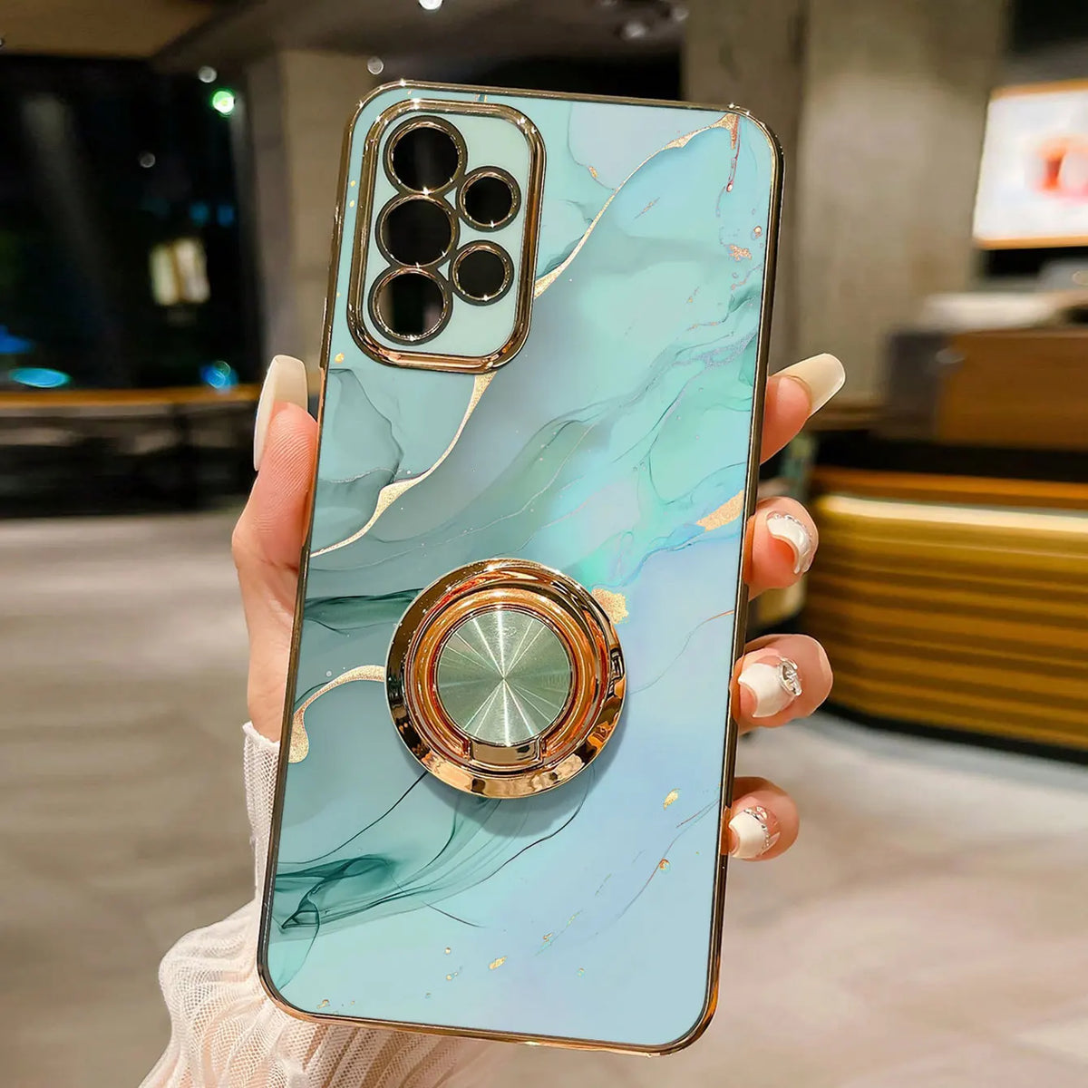 Phone case with ring stand featuring a marble pattern, designed for secure grip and stylish protection, by Corporación Turística.